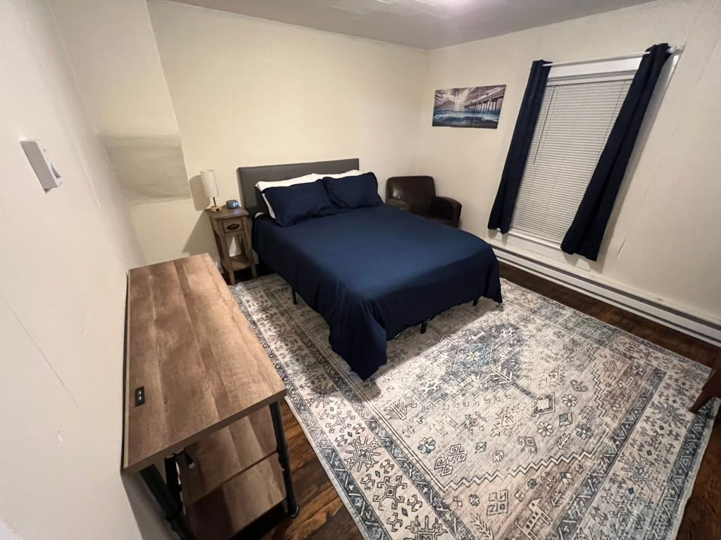 A kitchen with white cabinets , a sink , a microwave , and a stove.