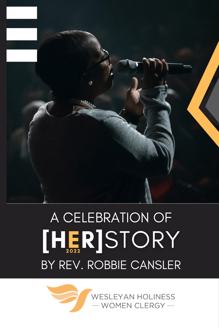 Black woman singing into mic on stage. White Text on Black Background. A Celebration of HER story E2022. By Robbie Cansler.