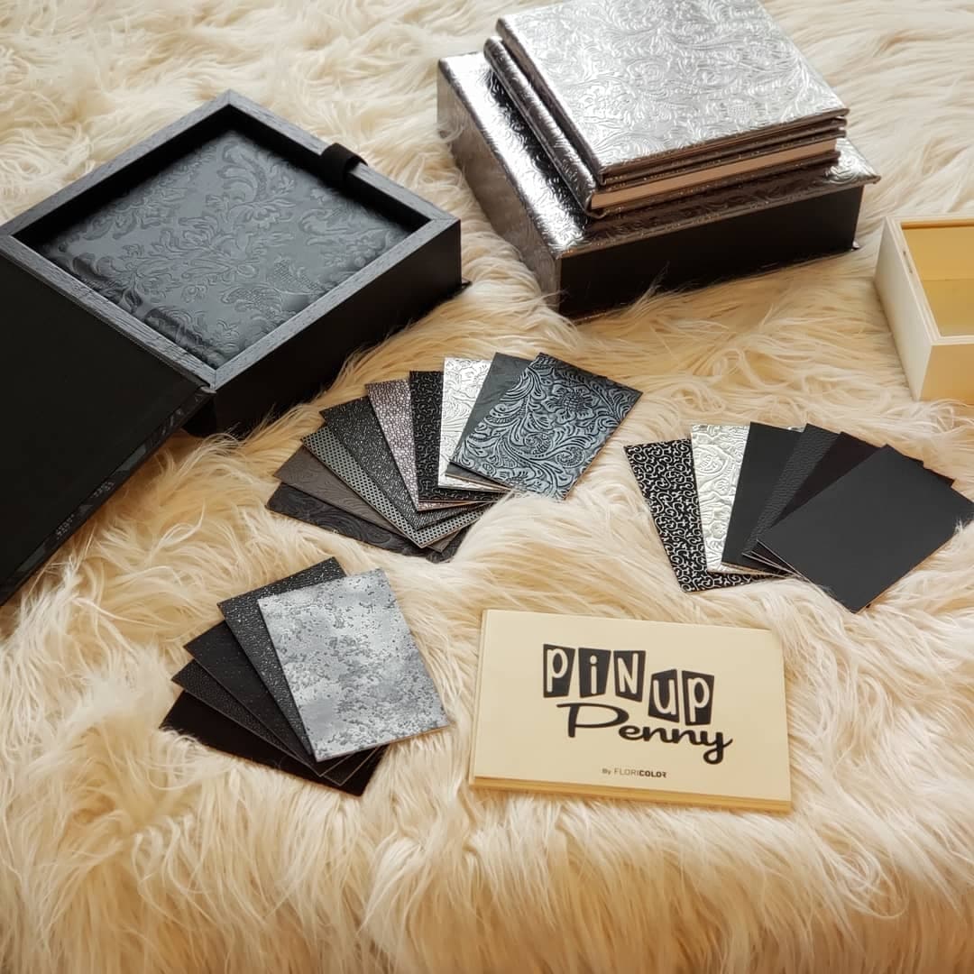 a box of pin up penny cards sits on a fur rug