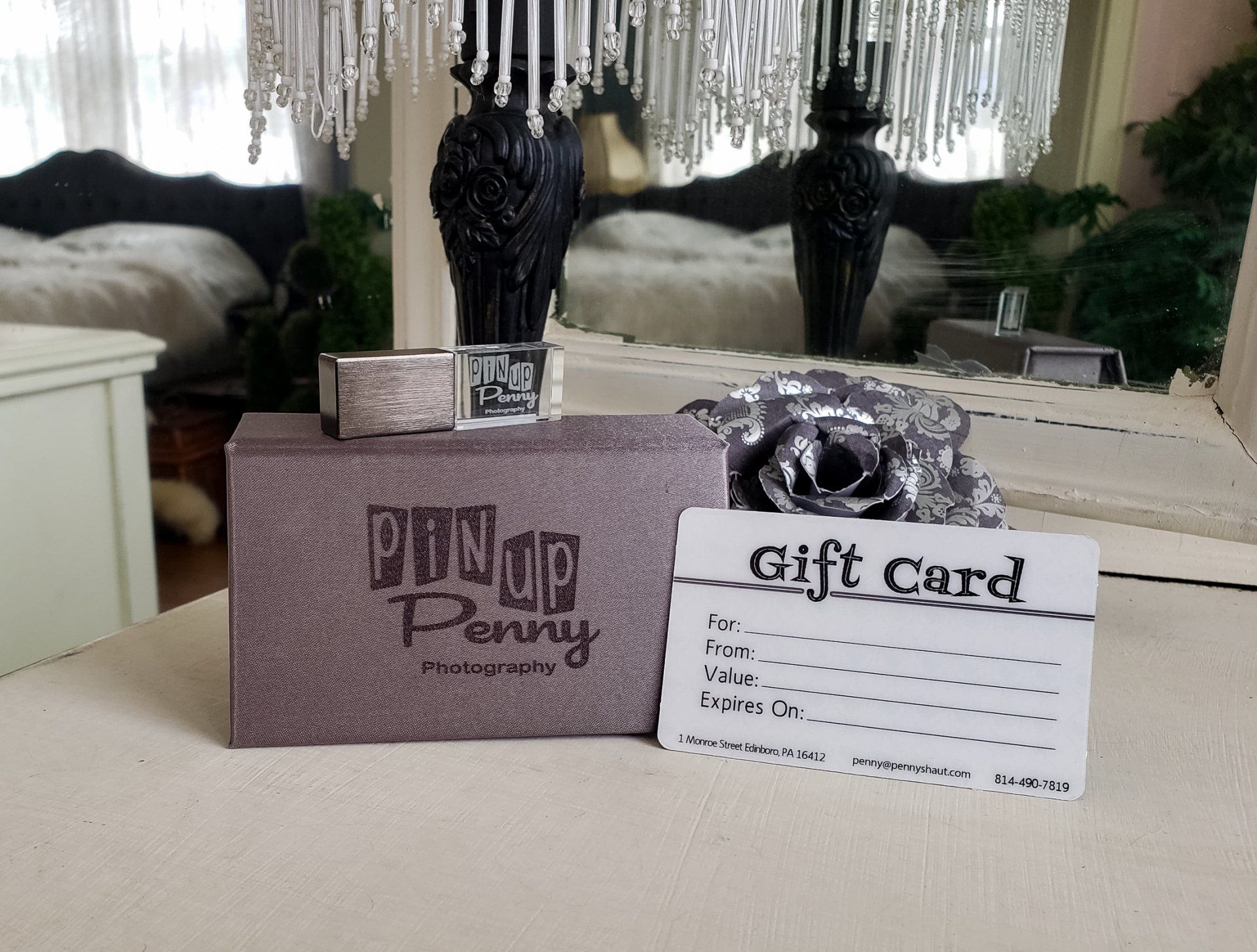 a gift card is sitting on a table in front of a mirror
