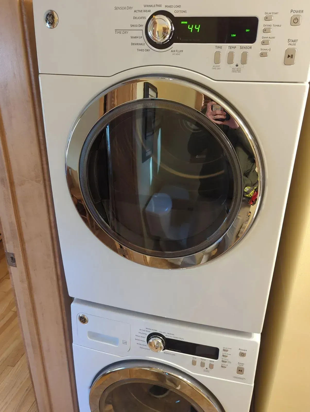 A white washer and dryer are stacked on top of each other