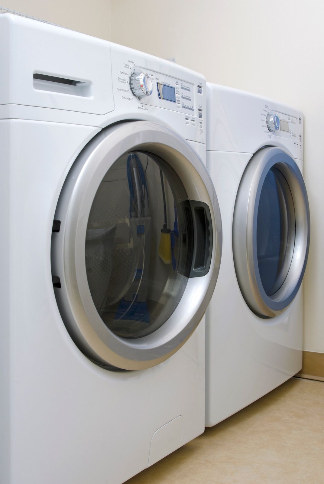 A washer and dryer are sitting next to each other in a laundry room.