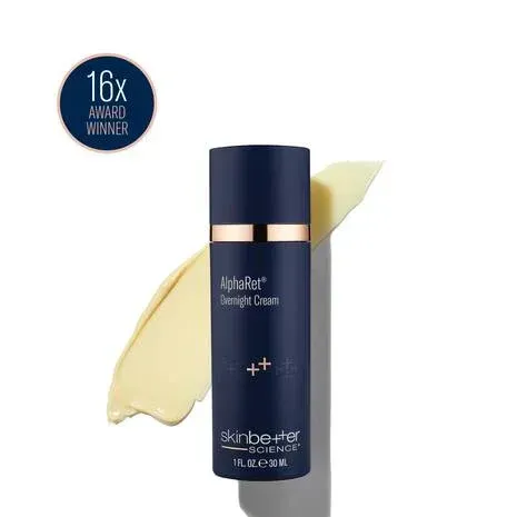 Dark blue skincare bottle of overnight cream with yellow cream smear, white background, 
