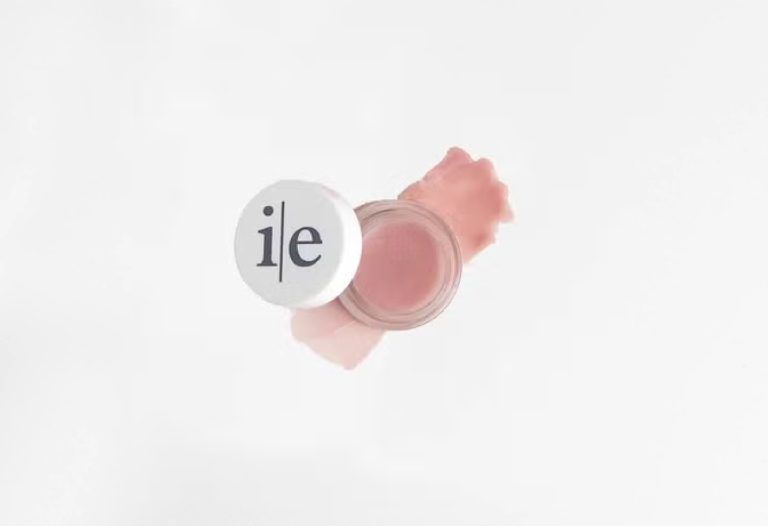 Lip and cheek tint pot with swatch on white background.