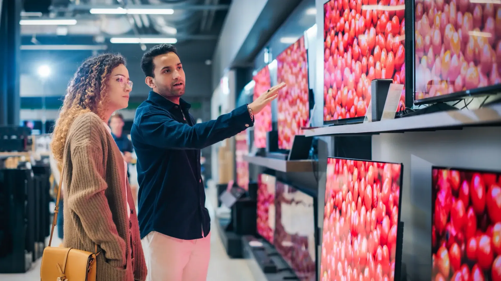 A person is holding a pineapple in a bag in a grocery store.