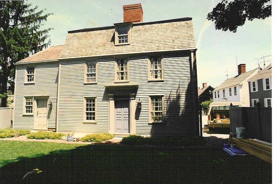A large white house with a brick chimney on top of it