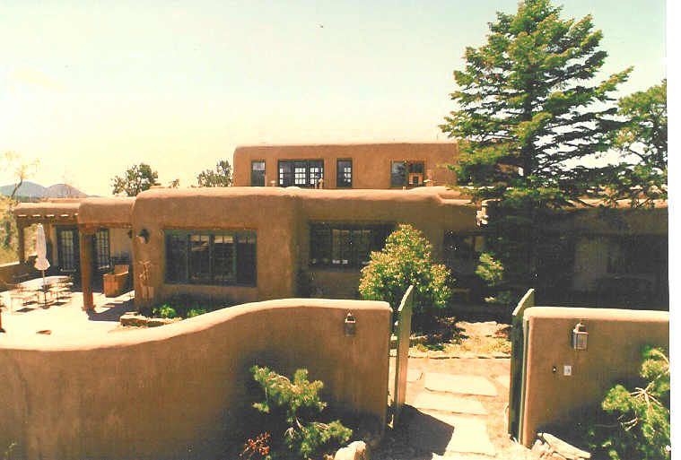A picture of a house with a tree in the background