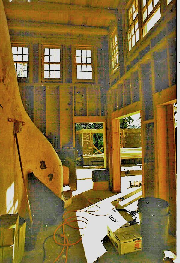 A picture of a house under construction with boxes on the floor