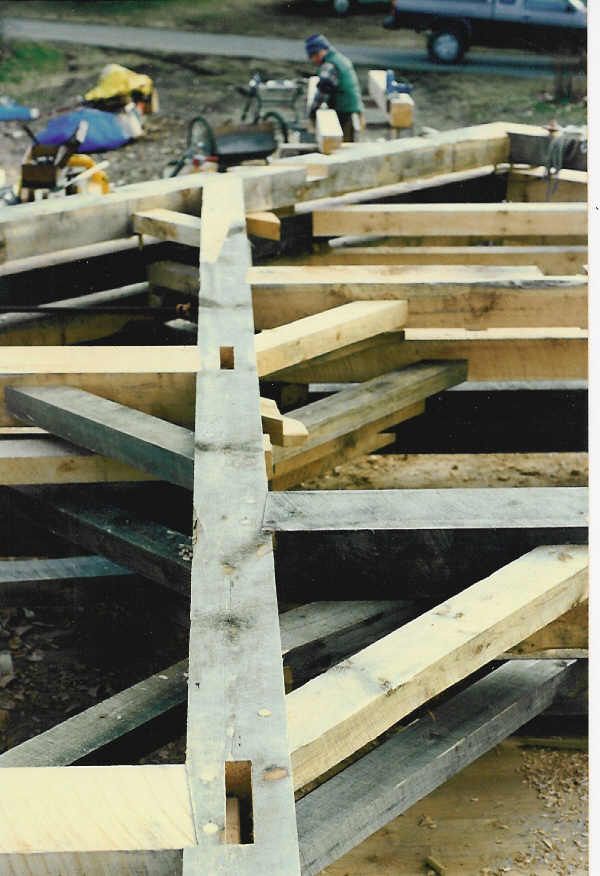 A bunch of wooden beams are stacked on top of each other