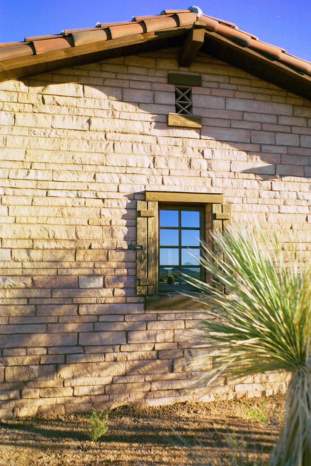 A kitchen with blue cabinets and a light hanging from the ceiling