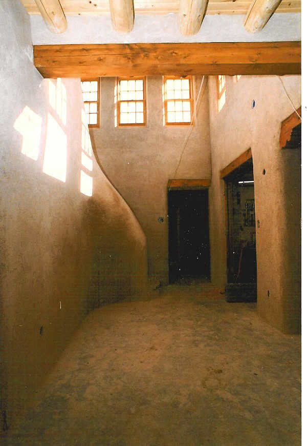 An empty room with a staircase and wooden beams