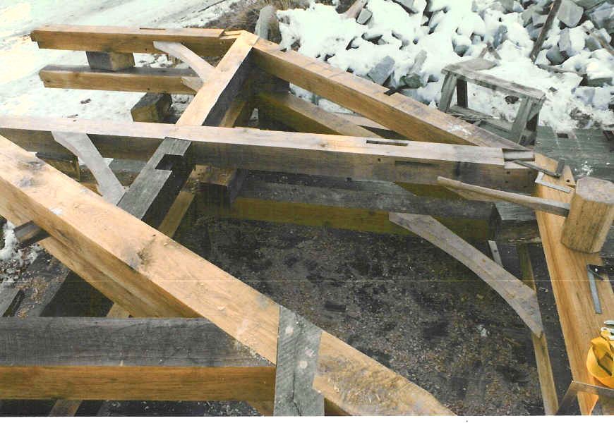 A bunch of wooden beams are laying on the ground