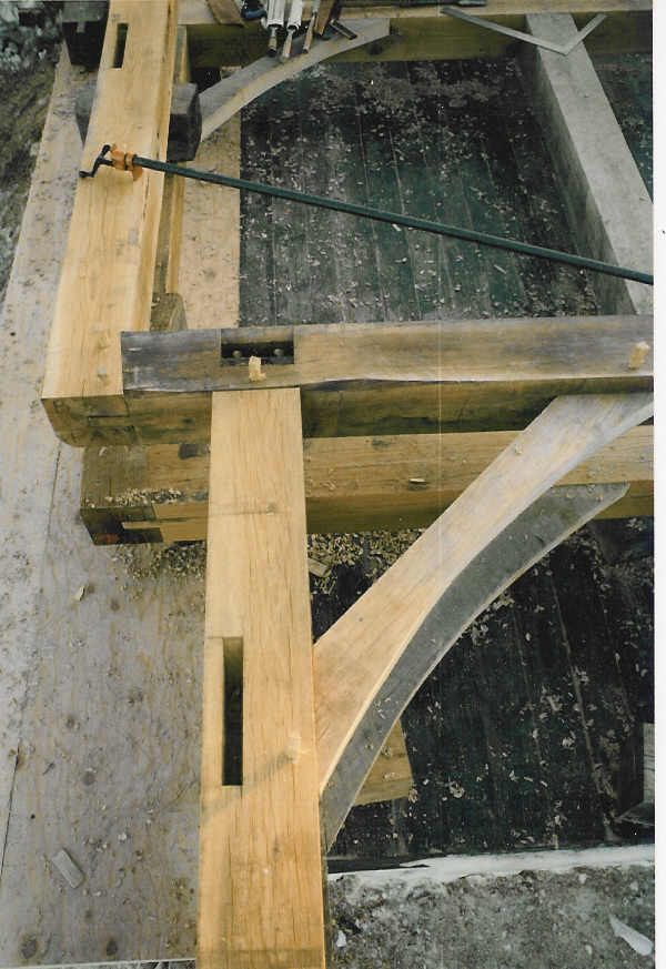 A wooden structure is being built with a circular saw.