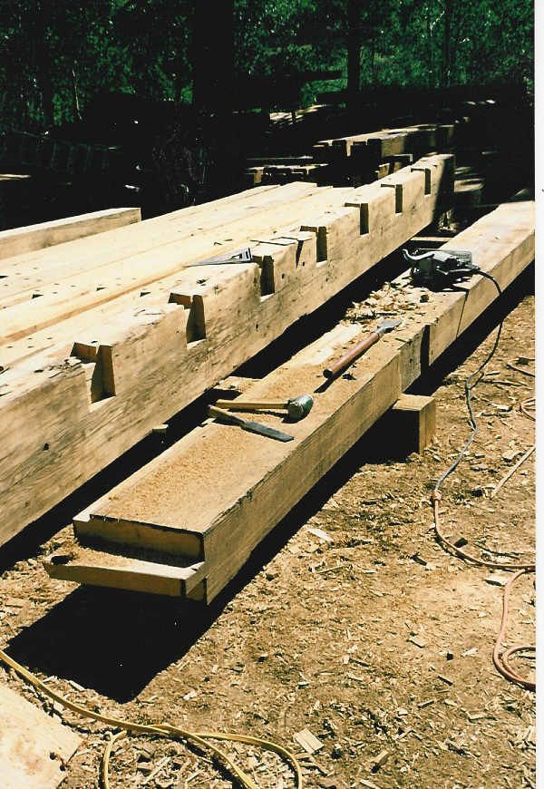 A bunch of wooden beams are laying on the ground