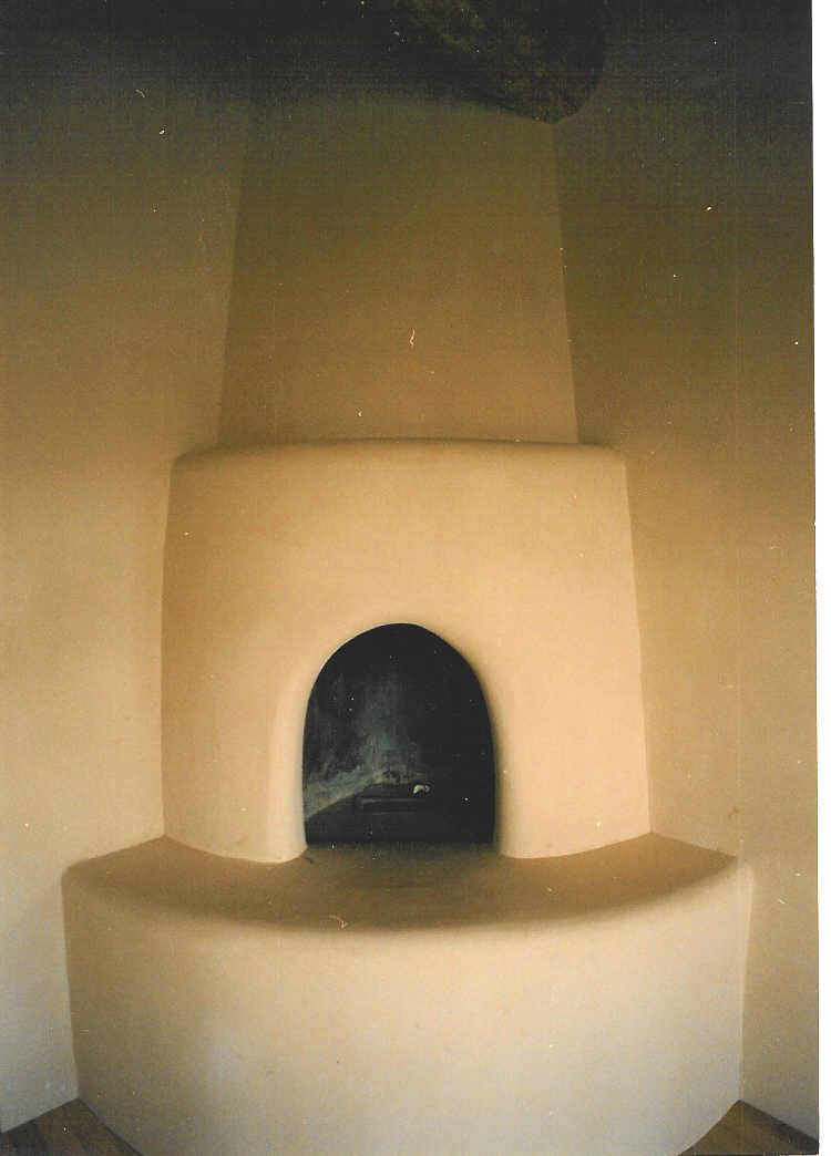 There is a fireplace in the corner of the room.