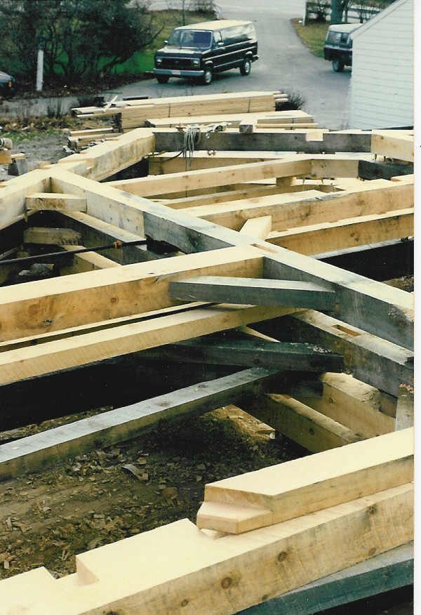 A bunch of wooden beams are stacked on top of each other