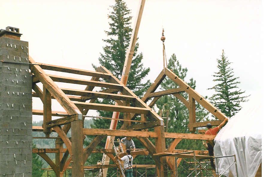 A wooden structure is being built in the woods