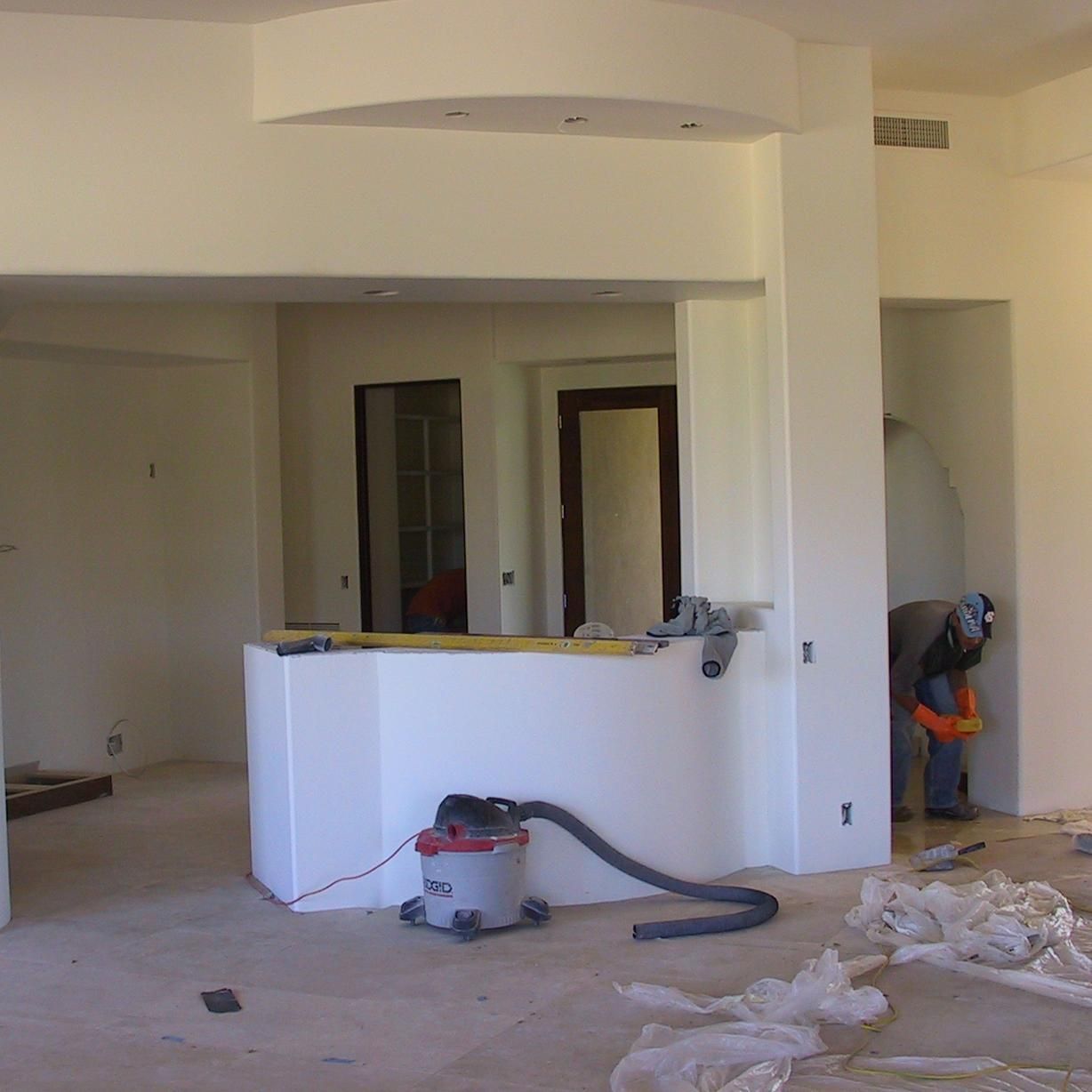 A vacuum cleaner is in the middle of a room