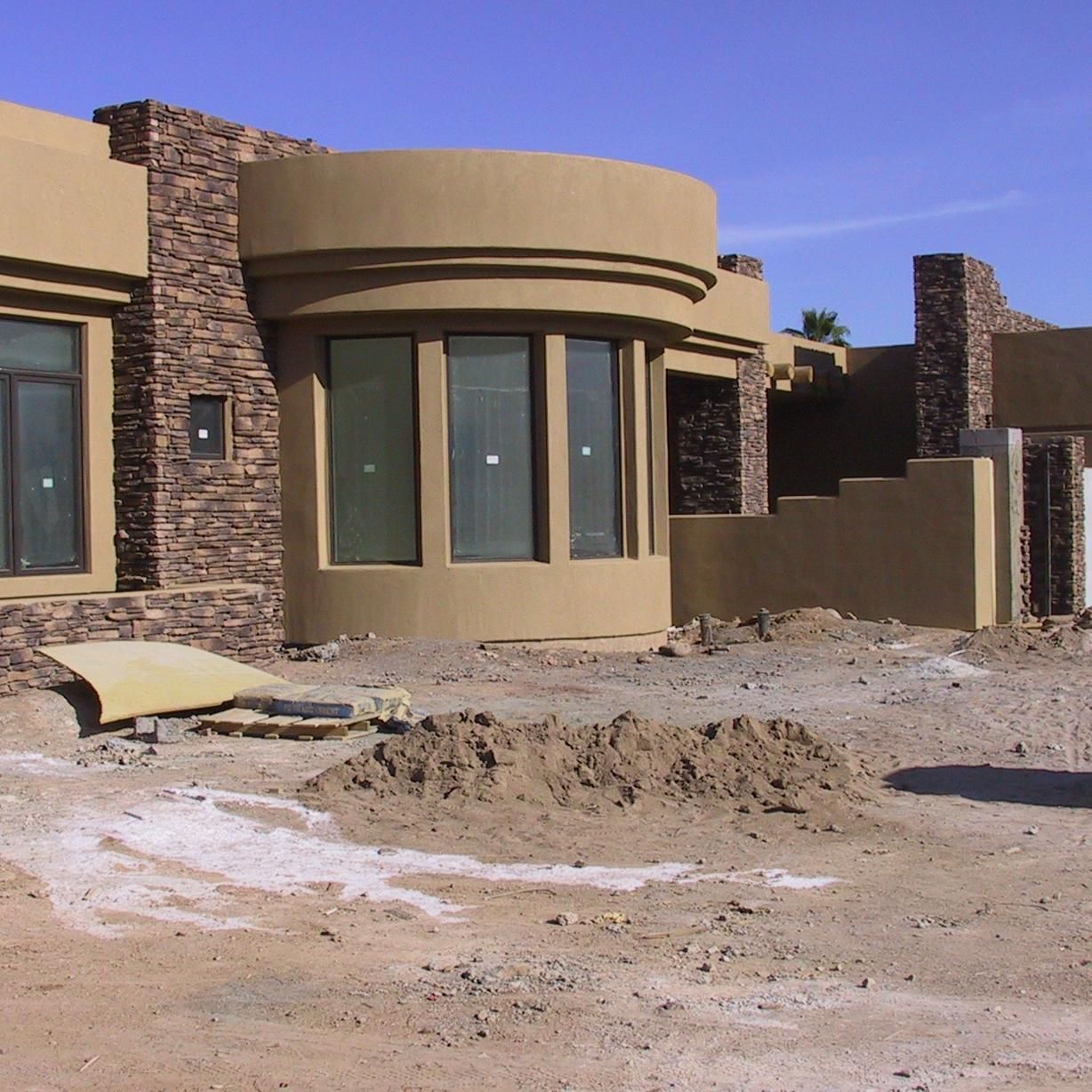A house that is being built with a lot of windows