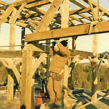 A man is working on a wooden structure.