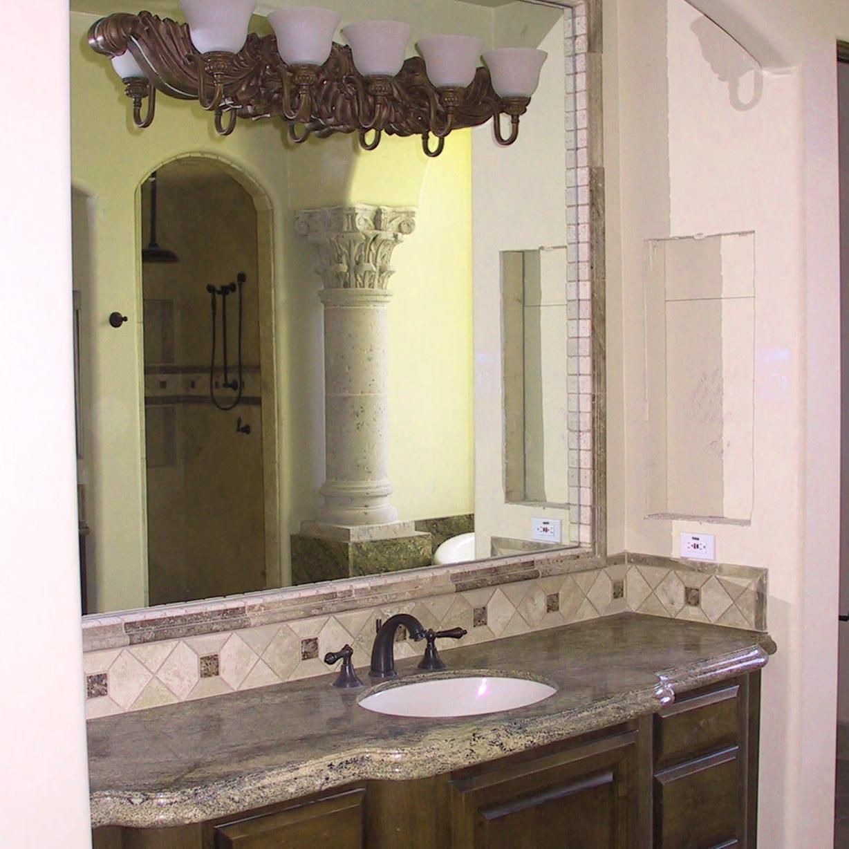 A bathroom with a sink and a large mirror
