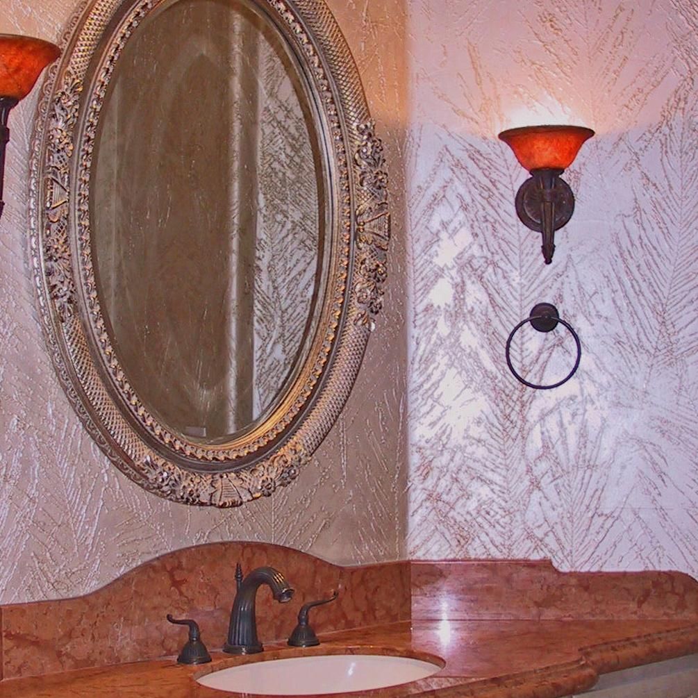 A bathroom with a sink a mirror and two lamps