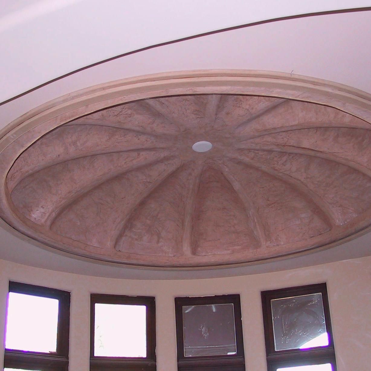 A dome shaped ceiling in a room with windows