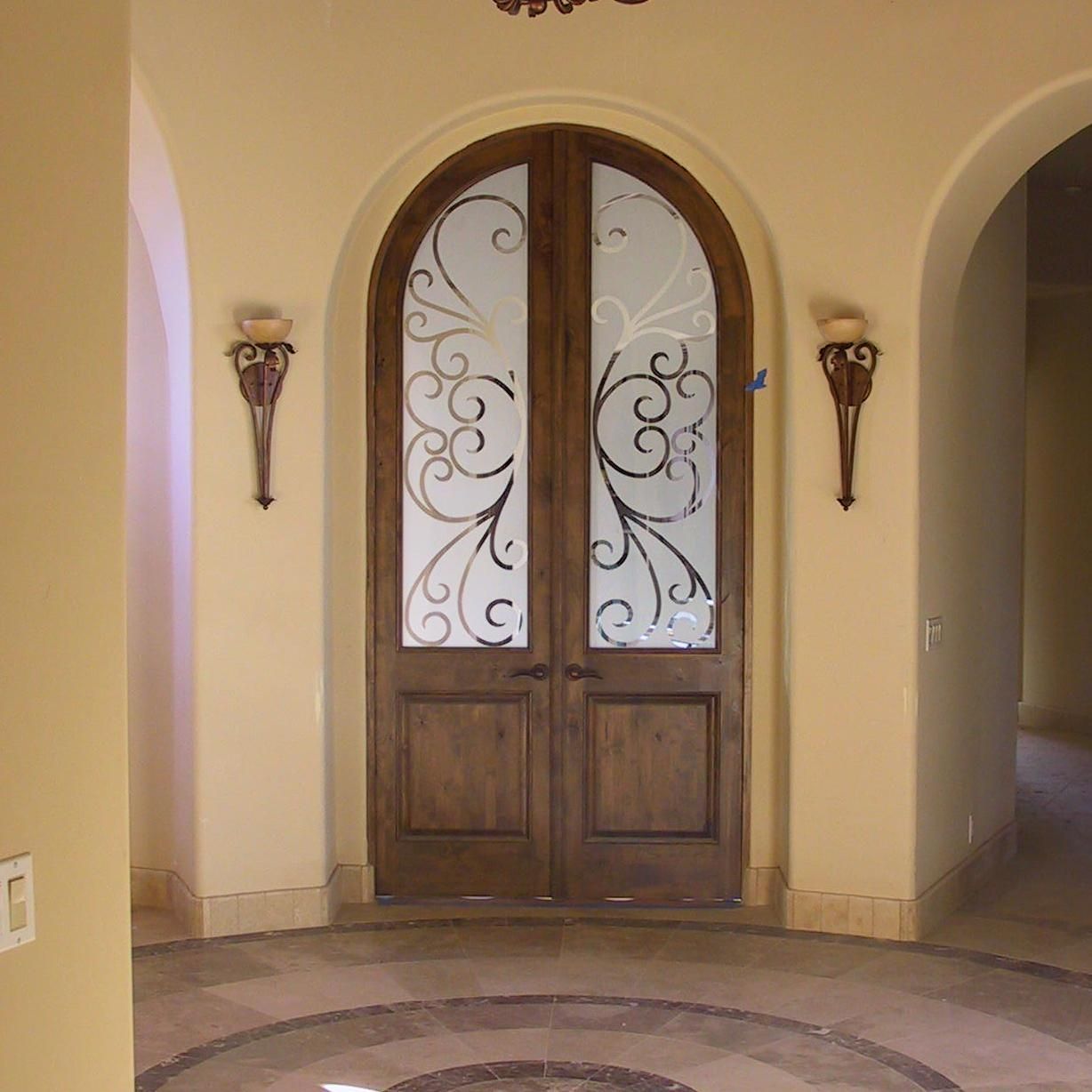 A door with a swirl design on the glass