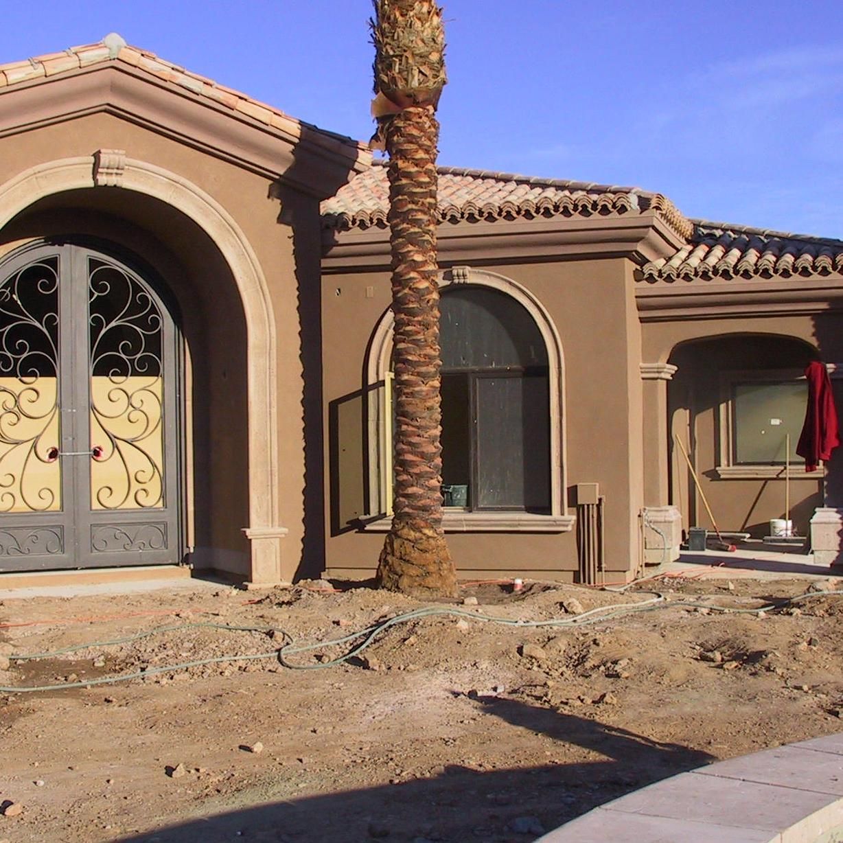 A house with a palm tree in front of it