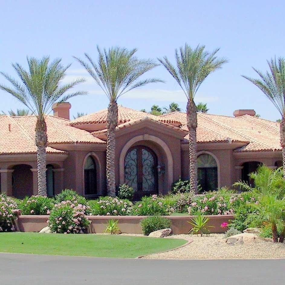 A large house with palm trees in front of it