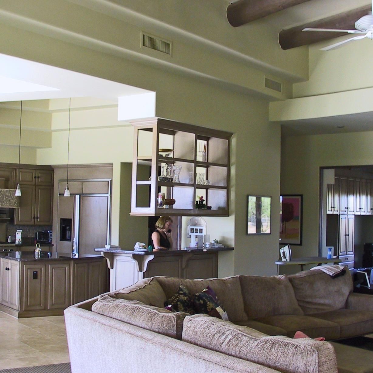 A living room with a couch and a ceiling fan