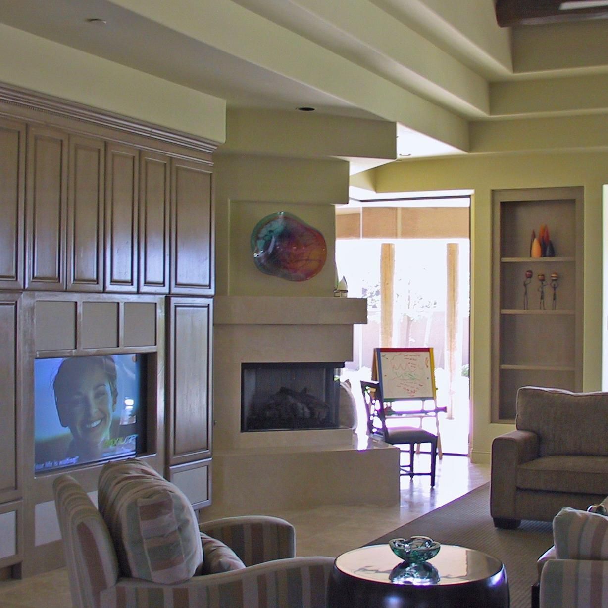 A living room with a fireplace and a flat screen tv