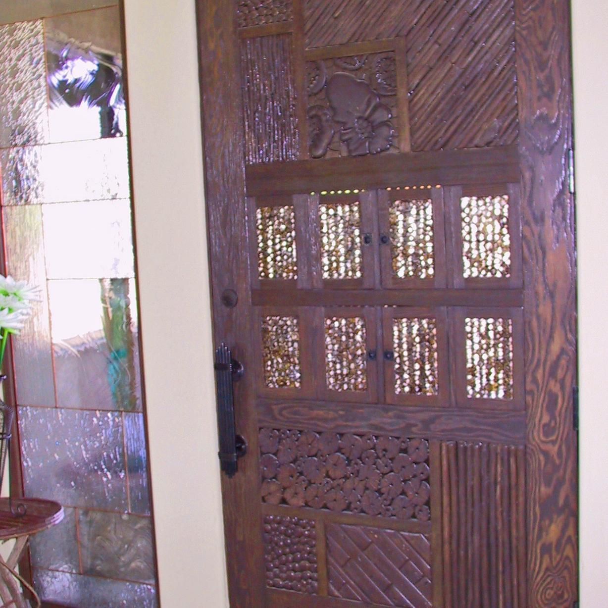 A wooden door with a mirror behind it