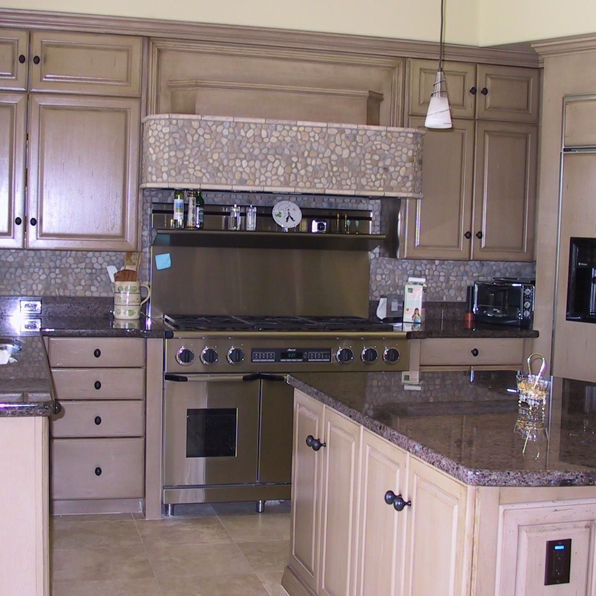 A kitchen with stainless steel appliances and granite counter tops