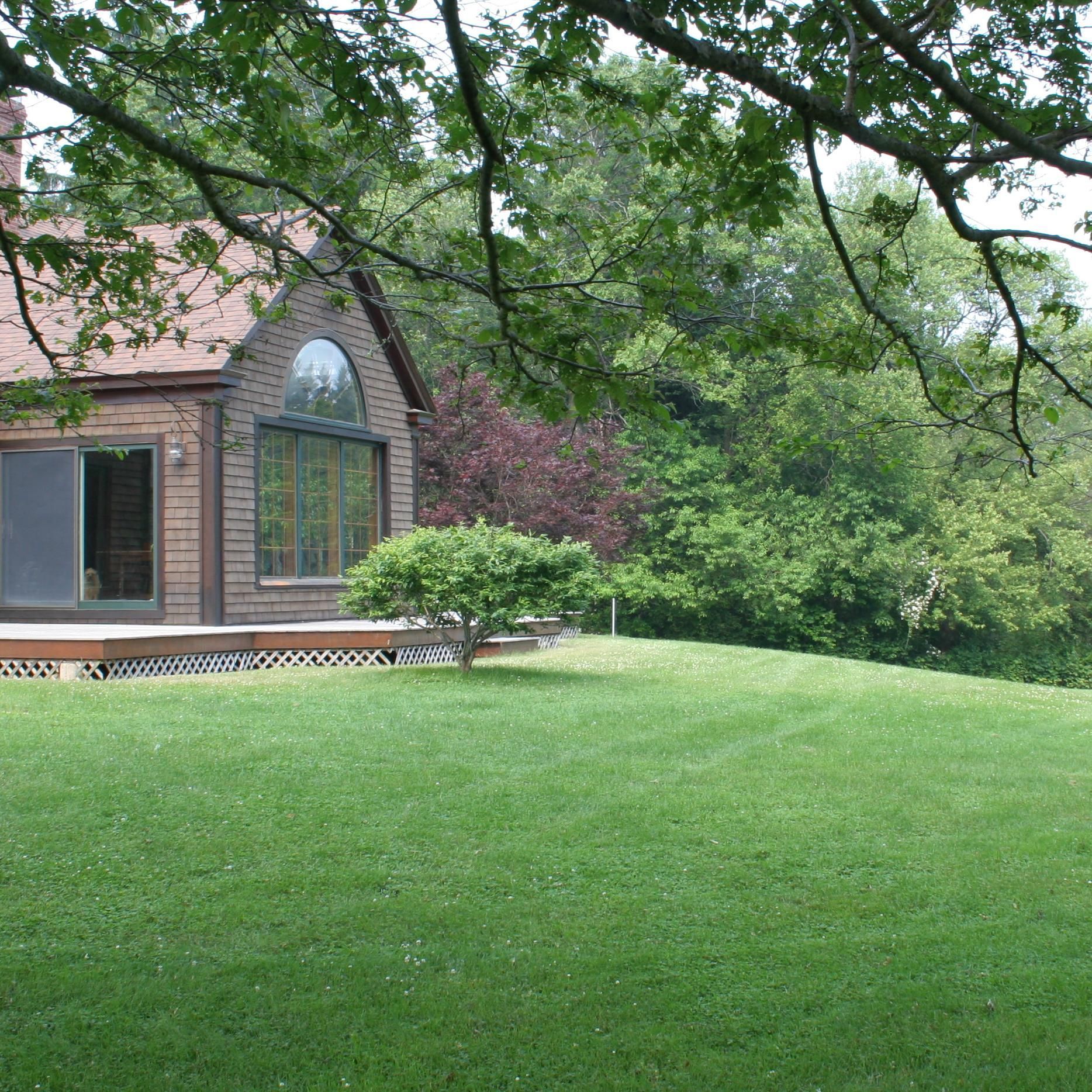 A house with a large lawn in front of it