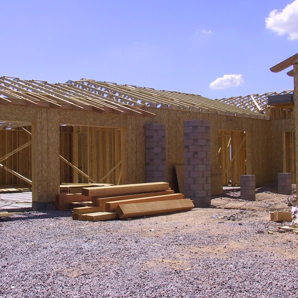 A house that is being built with a blue sky in the background