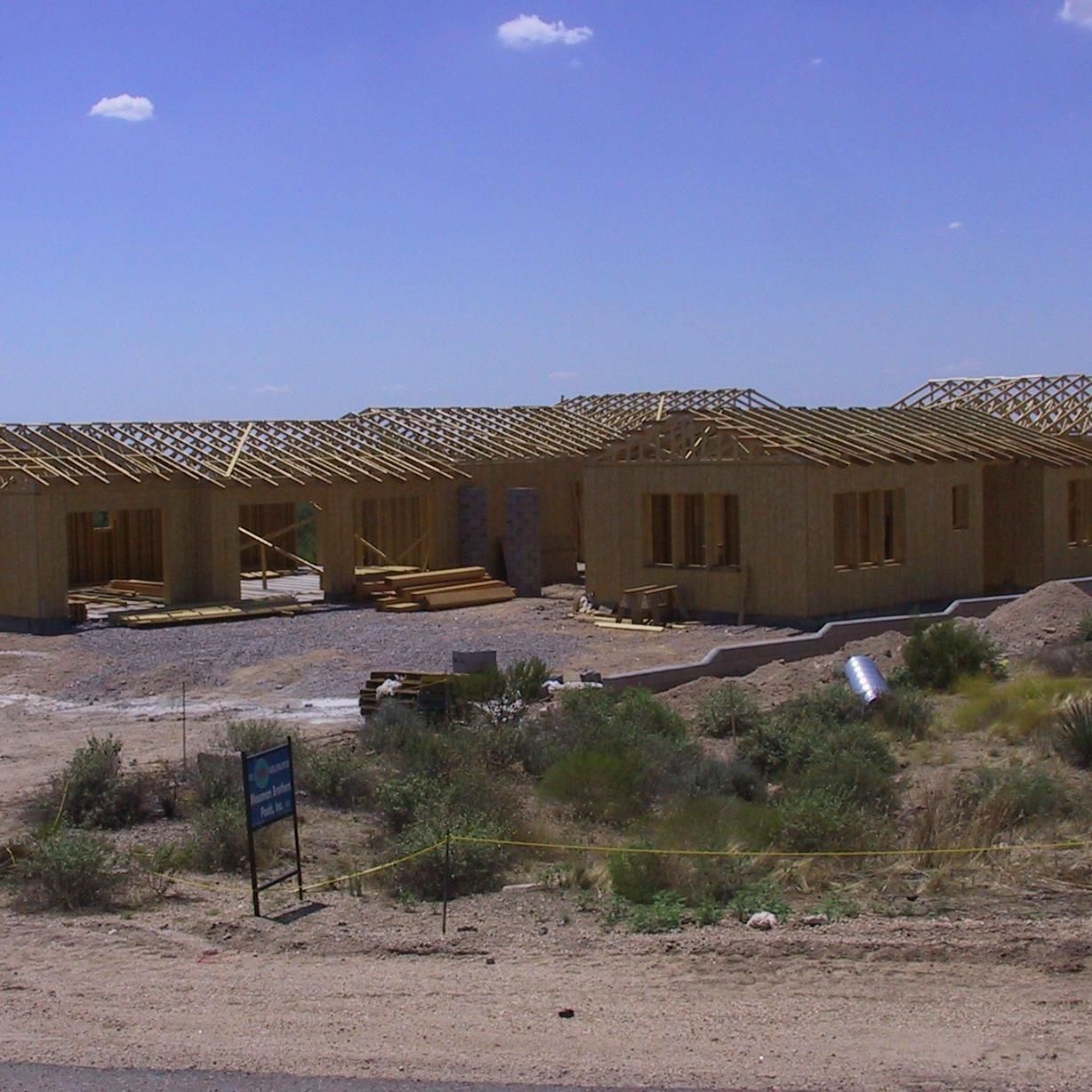 A row of houses are being built in the desert