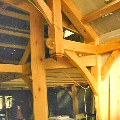 A room with a lot of wooden beams and a ceiling.