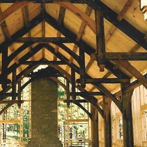 A large wooden structure with a chimney in the middle