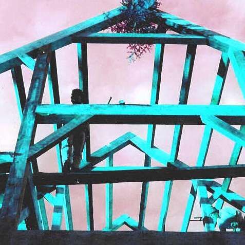 A person is standing on top of a wooden structure.