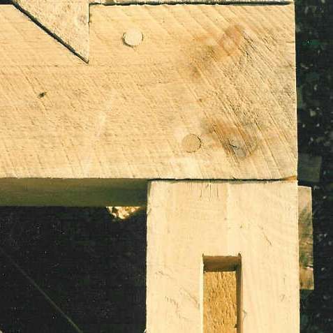 A close up of a piece of wood with a hole in it.