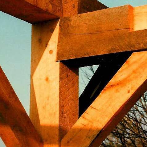 A close up of a wooden structure with trees in the background