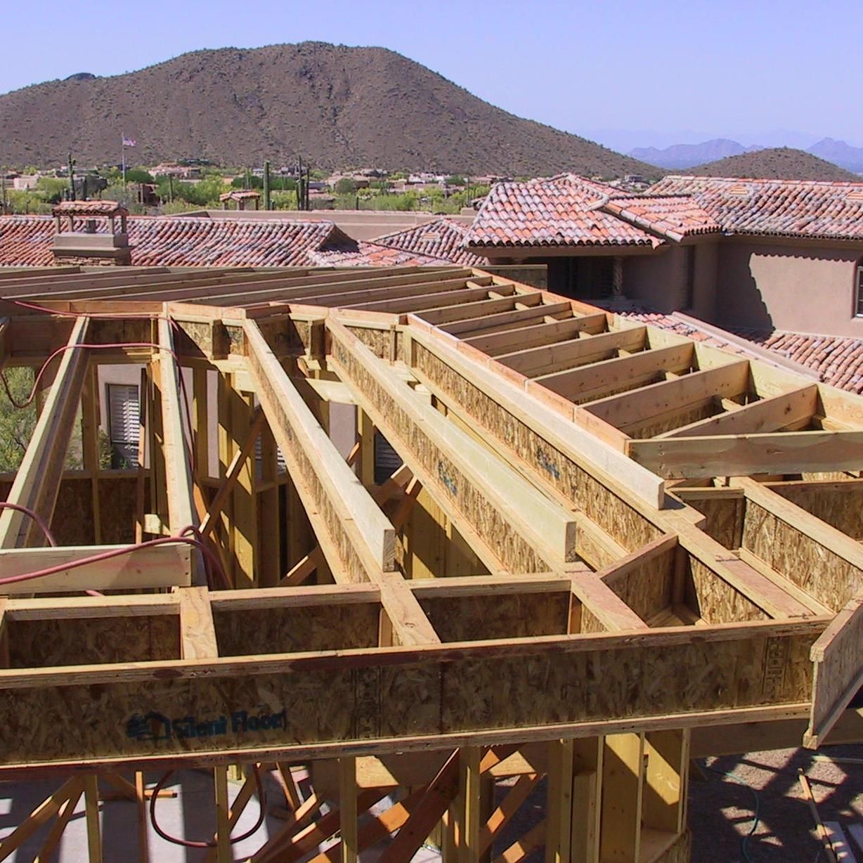 A house under construction with a mountain in the background