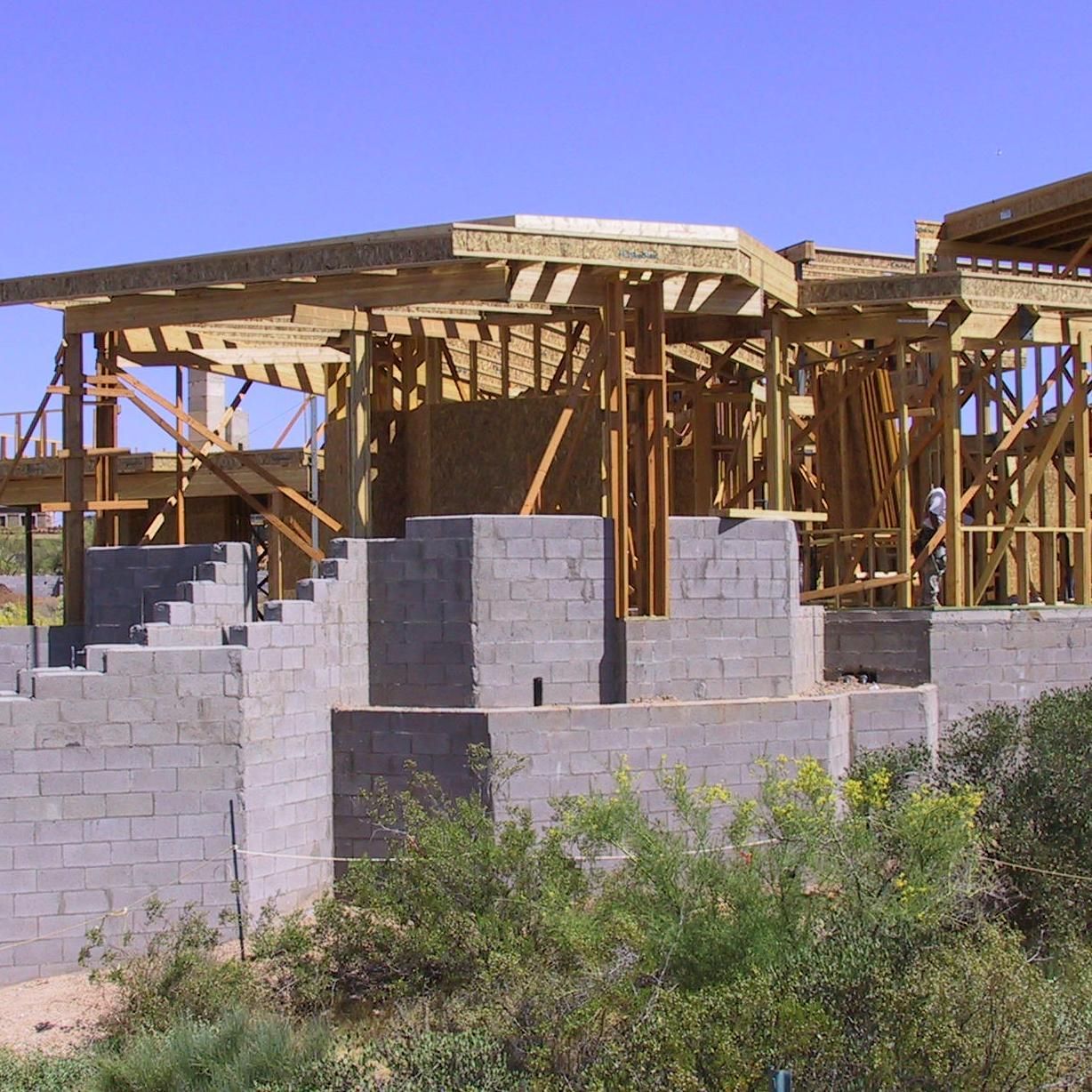 A house that is being built with bricks and wood