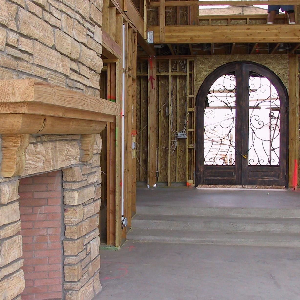 A brick fireplace in a house under construction
