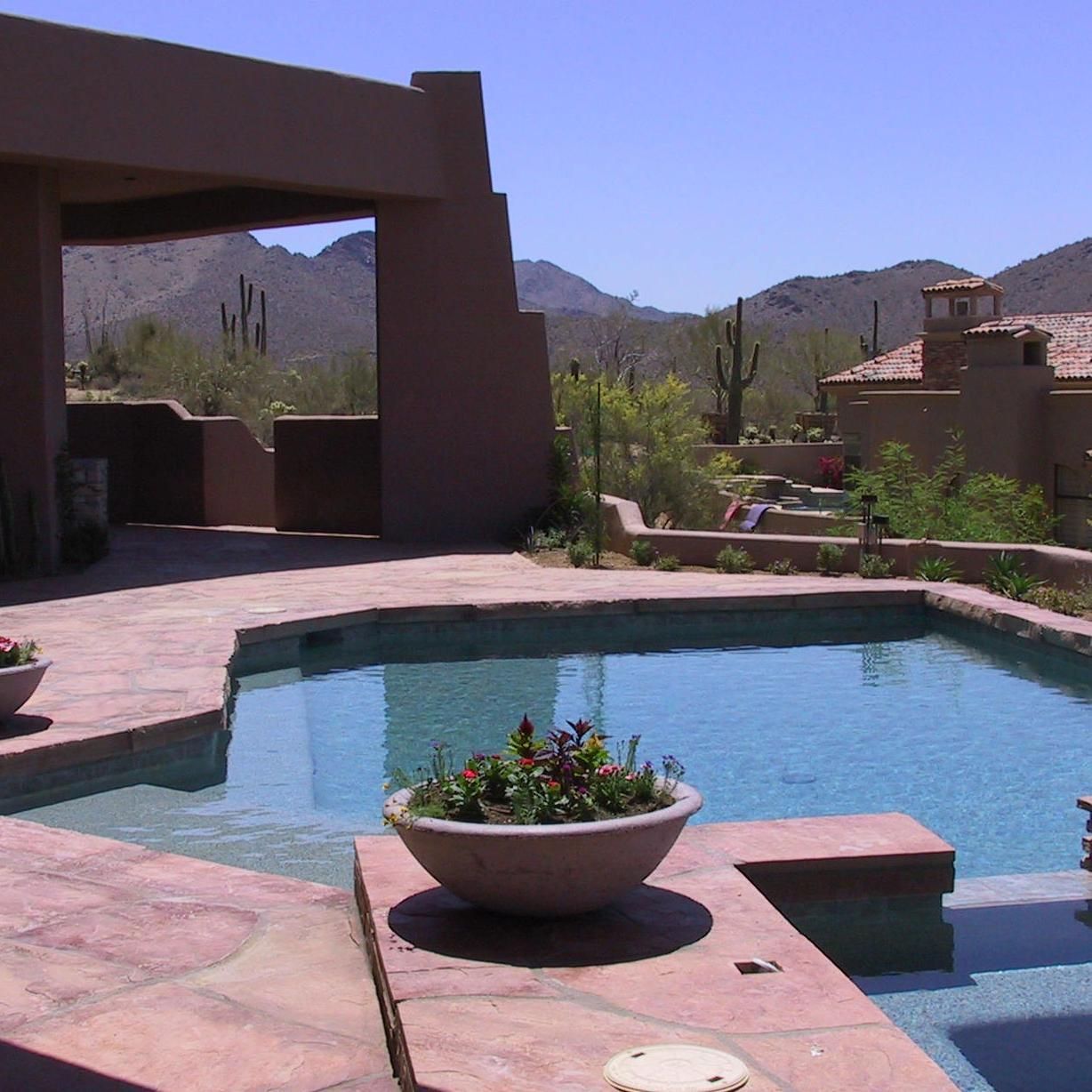 A large swimming pool with mountains in the background
