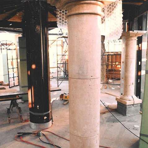 A building under construction with columns and scaffolding