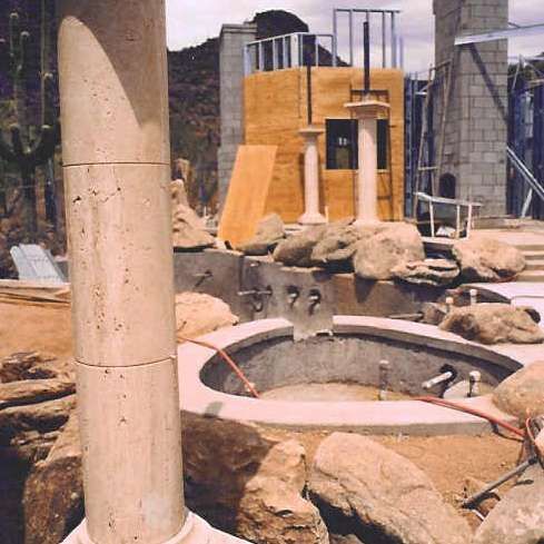 A building under construction with a pool in the middle