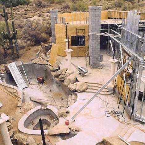 An aerial view of a building under construction in the desert