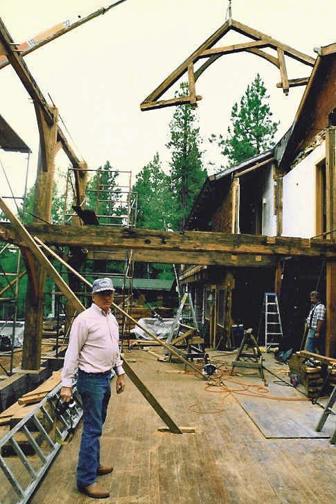 A man standing in front of a building under construction